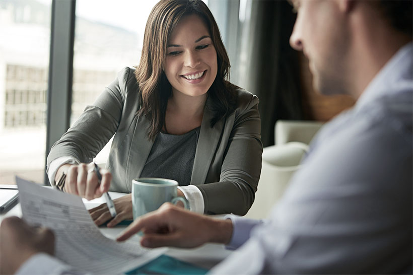 wealth manager and client discussing numbers